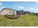 Spacious backyard with grassy lawn and screened patio at 537 Narrow View Ln, Groveland, FL 34736