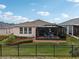 Home features a screened patio and fenced backyard at 537 Narrow View Ln, Groveland, FL 34736