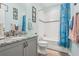 Bathroom with tub, shower, granite countertop, and gray cabinets at 537 Narrow View Ln, Groveland, FL 34736