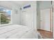 Bedroom with double closet, window, and hardwood floor at 537 Narrow View Ln, Groveland, FL 34736