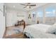Bedroom with hardwood floors, large windows and ceiling fan at 537 Narrow View Ln, Groveland, FL 34736