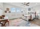 Bright bedroom with a ceiling fan, large windows, and hardwood floors at 537 Narrow View Ln, Groveland, FL 34736