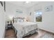 Cozy bedroom with a queen-size bed and wood flooring at 537 Narrow View Ln, Groveland, FL 34736