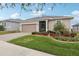 Landscaped yard and brick paver driveway at 537 Narrow View Ln, Groveland, FL 34736