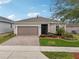 One-story home with attractive landscaping and two-car garage at 537 Narrow View Ln, Groveland, FL 34736