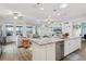 Open kitchen with island, stainless steel appliances, and view to living room at 537 Narrow View Ln, Groveland, FL 34736