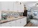 Kitchen with granite counters, white cabinets, and wine fridge at 537 Narrow View Ln, Groveland, FL 34736