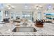 Kitchen island with sink, granite countertop and view of backyard at 537 Narrow View Ln, Groveland, FL 34736