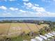 Beautiful aerial view of a large property with water access in the distance at 5415 Banana Point Dr, Okahumpka, FL 34762