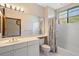 Bright bathroom with a combination shower-tub, large mirror with lights, and a spacious vanity area at 5415 Banana Point Dr, Okahumpka, FL 34762