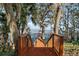 Wood stairs down to a wooden dock on the lake, inviting you to the waterfront for boating and enjoying the serene setting at 5415 Banana Point Dr, Okahumpka, FL 34762