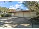 Spacious three-car garage offers plenty of parking and storage space with a sunny driveway at 5415 Banana Point Dr, Okahumpka, FL 34762