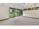 Bright living room featuring large windows with a picturesque view of lush greenery and outdoor space at 5415 Banana Point Dr, Okahumpka, FL 34762