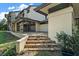 The back exterior of the house with an outdoor seating area and an accessible backyard is perfect for relaxation at 5415 Banana Point Dr, Okahumpka, FL 34762