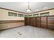 Study room with built-in dark wood bookshelves, carpet floor and small horizontal windows at 5415 Banana Point Dr, Okahumpka, FL 34762