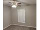 Comfortable bedroom with a ceiling fan, plush carpeting, and a window at 702 S Grand Hwy, Clermont, FL 34711