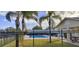 Inviting community pool area with palm trees and lounging chairs, perfect for relaxation and enjoyment at 702 S Grand Hwy, Clermont, FL 34711