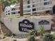 Landscaped entrance featuring the community signage for Hillside Villas, with street address at 702 S Grand Hwy, Clermont, FL 34711
