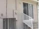 Here is an image of the back of the property showcasing the HVAC, electric meter, and small set of stairs at 702 S Grand Hwy, Clermont, FL 34711