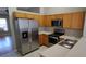 Bright kitchen features stainless steel appliances, wood cabinets, and ample counter space at 702 S Grand Hwy, Clermont, FL 34711