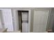 Convenient laundry closet with stacked washer and dryer unit and storage space at 702 S Grand Hwy, Clermont, FL 34711