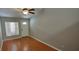 Bright living room features laminate flooring, a ceiling fan, and a neutral color palette at 702 S Grand Hwy, Clermont, FL 34711