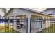 Community pool area featuring a covered picnic pavilion with table, and a secure black metal fence at 702 S Grand Hwy, Clermont, FL 34711