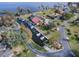 Aerial view of a waterfront community with private boat docks and luxurious homes along the water at 102 Cedar Way, Yalaha, FL 34797