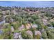 Stunning aerial view of lakeside homes with lush landscaping and access to water activities at 102 Cedar Way, Yalaha, FL 34797