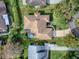Aerial view of the home, highlighting the landscaped yard, patio, and well-maintained roof at 102 Cedar Way, Yalaha, FL 34797