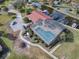 Aerial view of a home with a screened in pool and private boat dock at 102 Cedar Way, Yalaha, FL 34797