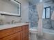 Bathroom featuring marble walls and cherry cabinets at 102 Cedar Way, Yalaha, FL 34797