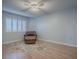 Bedroom with a decorative rug, ceiling fan, shuttered window, and comfortable leather chair at 102 Cedar Way, Yalaha, FL 34797