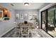 Formal dining room area with stylish rug and sliders to the outside at 102 Cedar Way, Yalaha, FL 34797