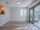 Bright dining area with wood floors and access to screened-in patio at 102 Cedar Way, Yalaha, FL 34797