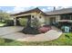 Charming single story home with attached garage and colorful landscaping at 102 Cedar Way, Yalaha, FL 34797