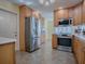 Well-lit kitchen featuring stainless steel appliances and light wood cabinetry at 102 Cedar Way, Yalaha, FL 34797