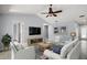 Spacious living room with vaulted ceilings, fan and lots of seating at 102 Cedar Way, Yalaha, FL 34797