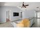 Open living room with vaulted ceilings, fan, and tile floors at 102 Cedar Way, Yalaha, FL 34797