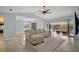 Bright and open living room with tile flooring and access to outdoor seating at 102 Cedar Way, Yalaha, FL 34797