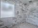 Luxury shower featuring marble tile and dual shower heads at 102 Cedar Way, Yalaha, FL 34797