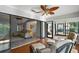 Sunroom featuring a ceiling fan, hardwood floors, comfortable seating, and sliding glass doors at 102 Cedar Way, Yalaha, FL 34797