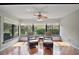 Bright sunroom with hardwood floors, large windows offering serene outdoor views, and comfortable seating at 102 Cedar Way, Yalaha, FL 34797