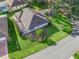 An aerial view of a single-story home showcasing the large, lush backyard, screened lanai, and nearby landscaping at 11584 Se 175Th St, Summerfield, FL 34491