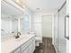 Bright bathroom featuring a large mirror, walk-in shower, and updated vanity with white countertops at 11584 Se 175Th St, Summerfield, FL 34491
