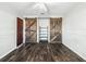 Spacious bedroom featuring dark wood flooring, and decorative barn doors with matching hardware at 11584 Se 175Th St, Summerfield, FL 34491
