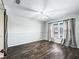Empty bedroom featuring dark wood flooring, and light grey walls, with barn door access at 11584 Se 175Th St, Summerfield, FL 34491