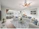 Bright living room with hardwood floors, white sofas with blue pillows, and an open layout to the dining area at 11584 Se 175Th St, Summerfield, FL 34491