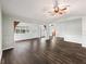 Spacious living room with dark hardwood floors and neutral-toned walls, creating a modern and inviting space at 11584 Se 175Th St, Summerfield, FL 34491