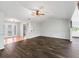 Open-concept living room with dark hardwood floors and neutral walls, offering a versatile and inviting space at 11584 Se 175Th St, Summerfield, FL 34491